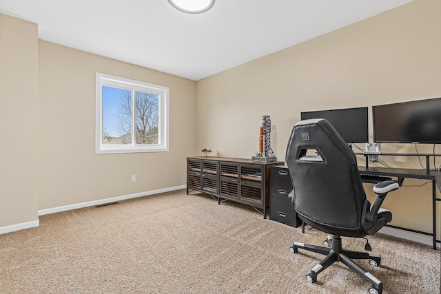 carpeted office space with visible vents and baseboards