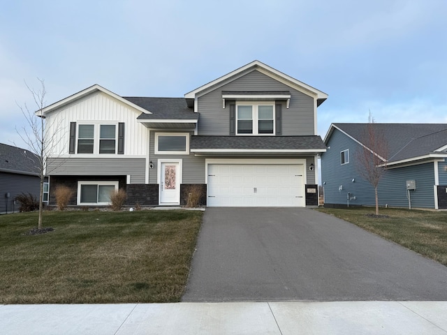 view of front of home featuring driveway, a front lawn, board and batten siding, a shingled roof, and a garage