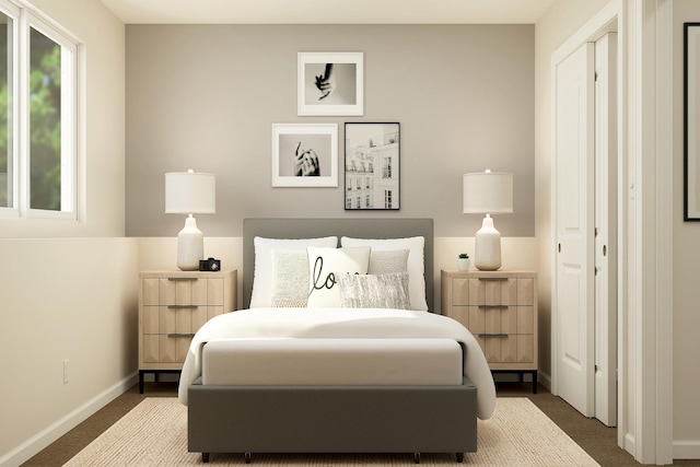 bedroom with baseboards and dark colored carpet