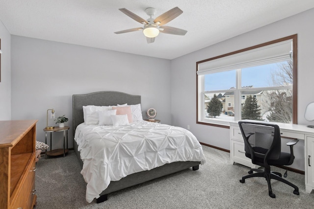 bedroom with carpet floors, a textured ceiling, and ceiling fan