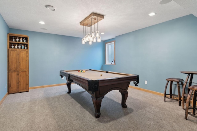 recreation room with light carpet, pool table, and a textured ceiling