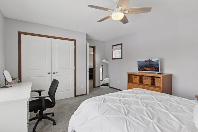 bedroom with ceiling fan, carpet, and a closet