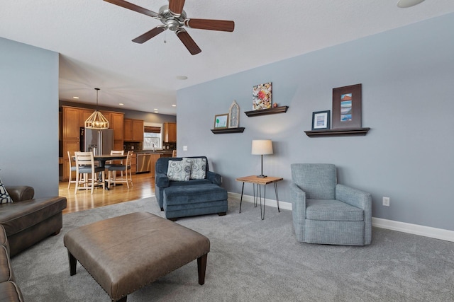 carpeted living room featuring ceiling fan