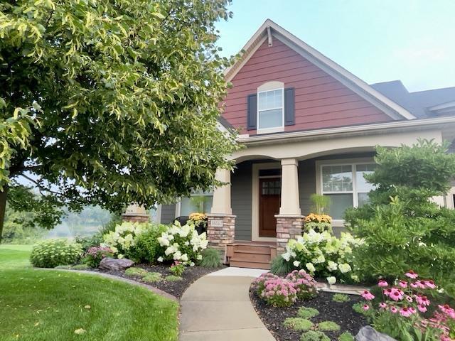 view of front of property featuring stone siding and covered porch