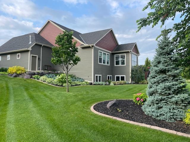 back of house with a lawn