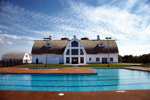 view of swimming pool featuring a yard and fence