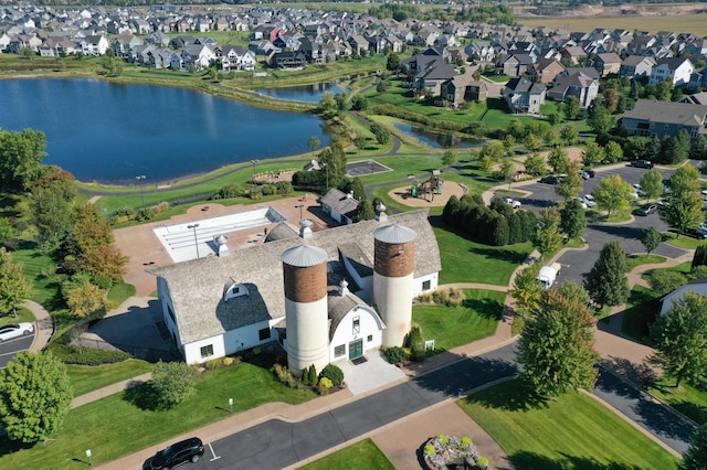 birds eye view of property with a residential view and a water view