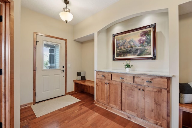 entryway featuring baseboards and light wood-type flooring