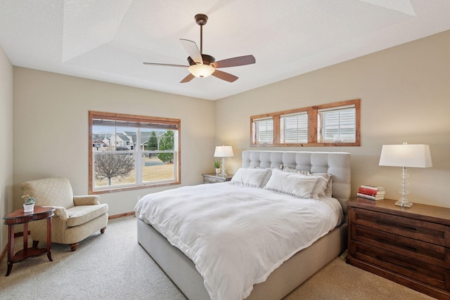 carpeted bedroom with baseboards and a ceiling fan