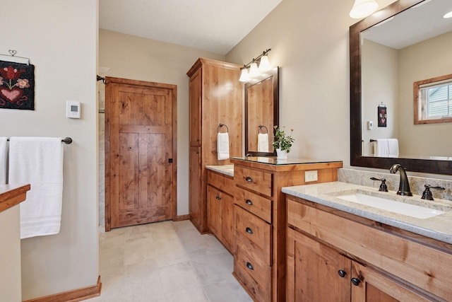 full bath with vanity and baseboards