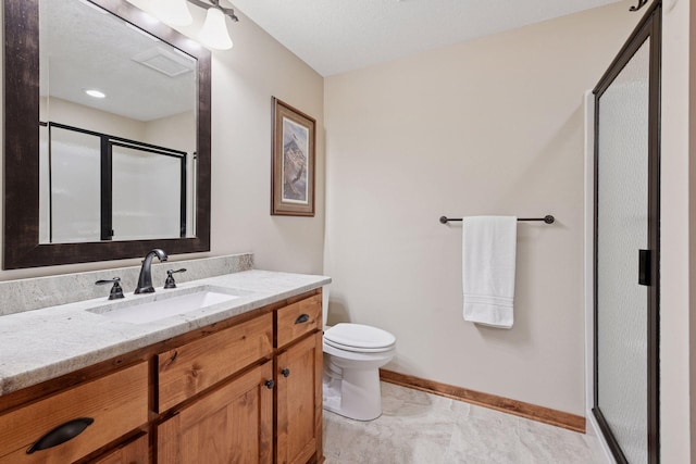 full bath featuring baseboards, toilet, a stall shower, and vanity