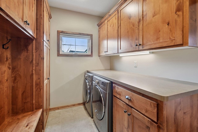 laundry area featuring cabinet space, washer and dryer, and baseboards