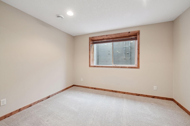 carpeted spare room with baseboards