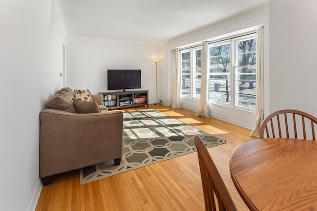 living room featuring baseboards and light wood finished floors