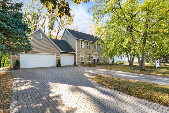 view of front of property featuring decorative driveway and an attached garage