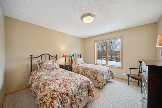 carpeted bedroom featuring a textured ceiling