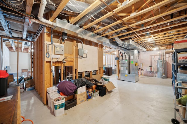 basement featuring water heater and heating unit