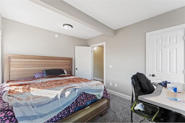 carpeted bedroom with beamed ceiling