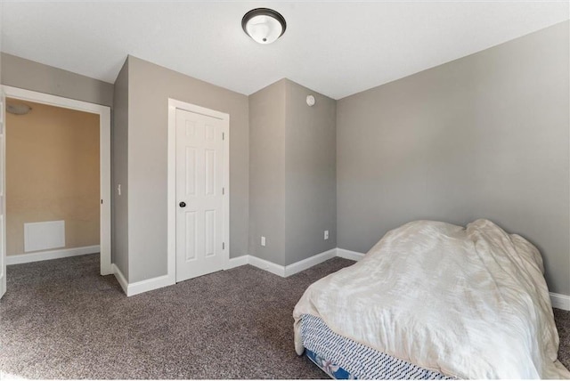 bedroom featuring dark colored carpet and a closet