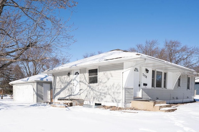 view of front facade featuring a garage and an outdoor structure