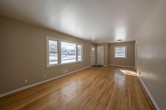 empty room with light hardwood / wood-style floors