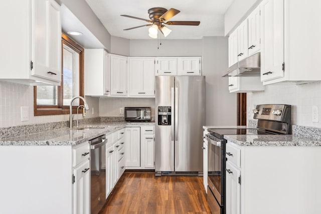 kitchen featuring white cabinets, light stone countertops, stainless steel appliances, and dark hardwood / wood-style flooring