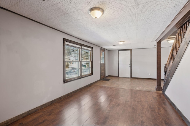 unfurnished room with dark hardwood / wood-style floors