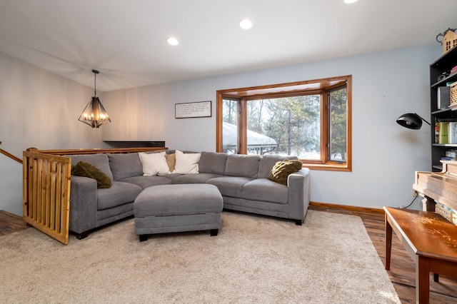 living room featuring a chandelier and wood-type flooring