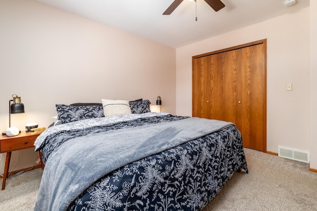 bedroom featuring light carpet, ceiling fan, and a closet