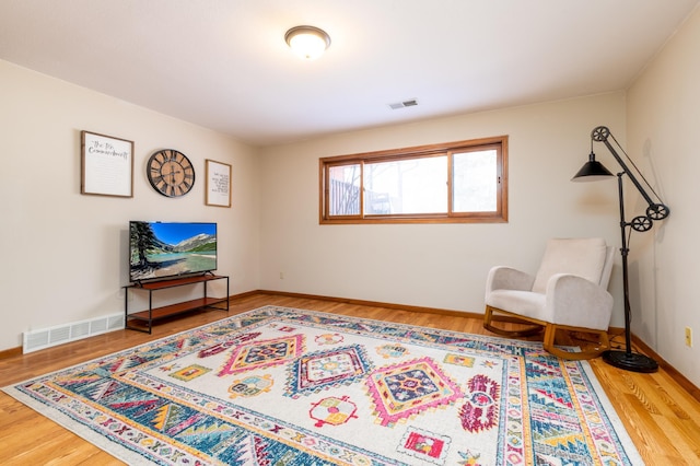 living area with hardwood / wood-style flooring