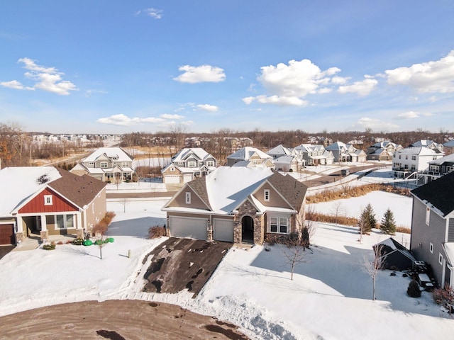 snowy aerial view with a residential view