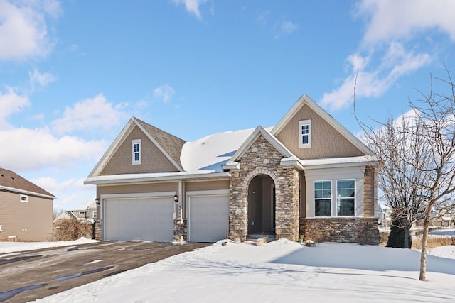 craftsman inspired home featuring a garage and stone siding