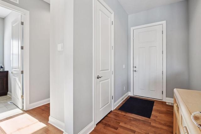 entrance foyer with light wood-style flooring and baseboards