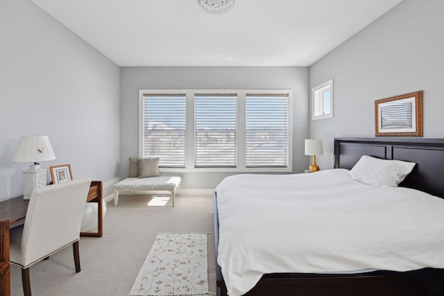 carpeted bedroom featuring baseboards