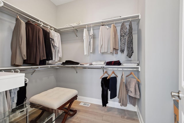 walk in closet featuring visible vents and wood finished floors