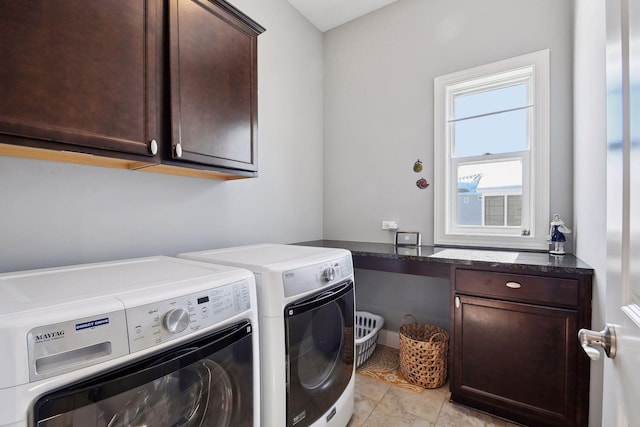 laundry room with light tile patterned floors, washer and clothes dryer, and cabinet space