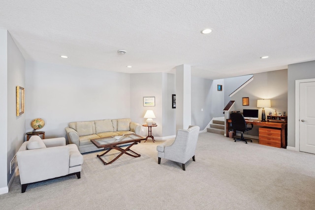 living area featuring a textured ceiling, recessed lighting, baseboards, and light colored carpet