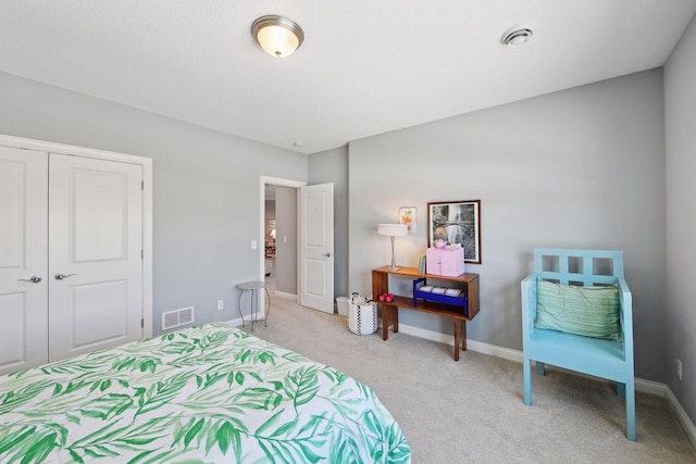 bedroom featuring baseboards, visible vents, a closet, and light colored carpet