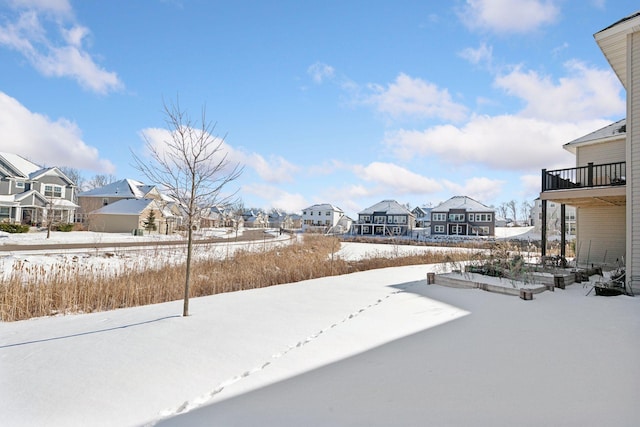 yard layered in snow with a residential view