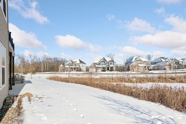 snowy yard with a residential view