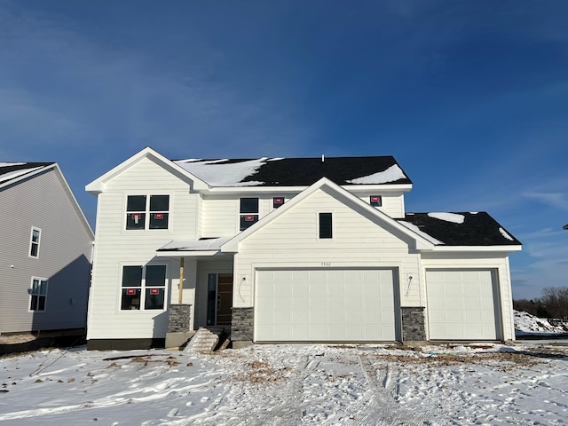 modern farmhouse with an attached garage and stone siding