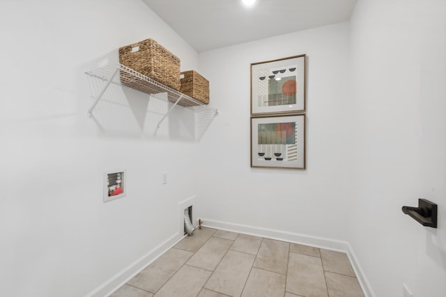 laundry area with light tile patterned floors, laundry area, washer hookup, and baseboards