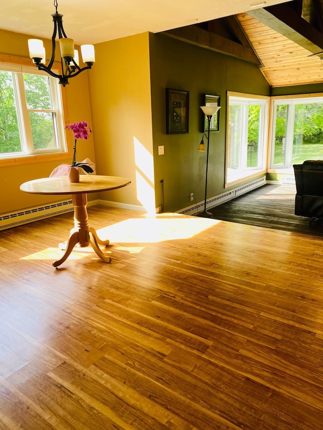 unfurnished dining area featuring hardwood / wood-style floors, a notable chandelier, and baseboard heating