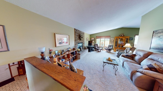 living room featuring lofted ceiling, a fireplace, a textured ceiling, and light colored carpet