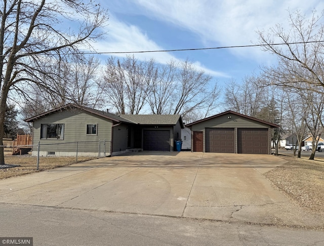 view of front of house with an attached garage and fence