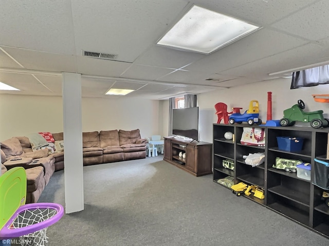 basement featuring visible vents, carpet flooring, and a paneled ceiling