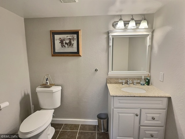 bathroom with visible vents, toilet, tile patterned flooring, baseboards, and vanity