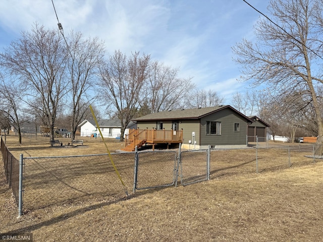 view of front of property featuring a wooden deck, fence private yard, and a gate