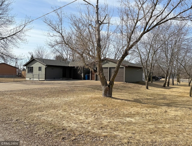 view of front of home featuring an outbuilding and fence