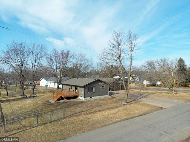 view of front of house with a deck, driveway, fence private yard, and a front lawn